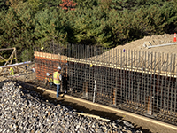 Worker looks over forms and rebar.